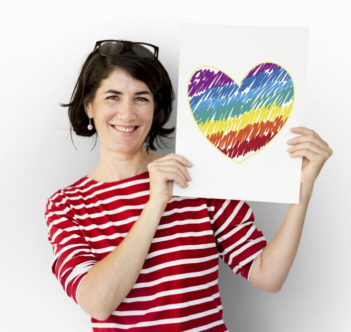 Woman holding placard with heart icon