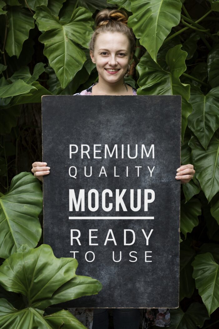 A lady holding a poster mockup 