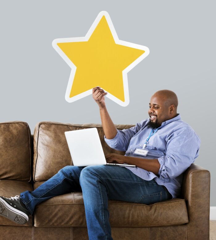 Man holding a star rating sitting on a couch