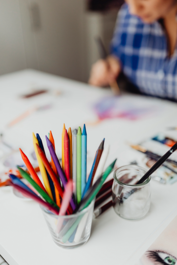 Art Printing And Framing: A woman creating art with colored pencils