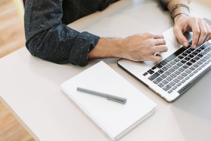 ecommerce SEO tips: Man working on his laptop in the office