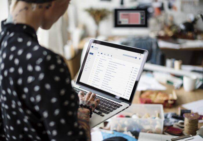 Ecommerce Tools: A woman looking at her email on a laptop 