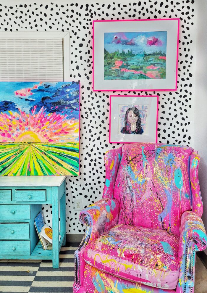 Colorful picture frames above a chair