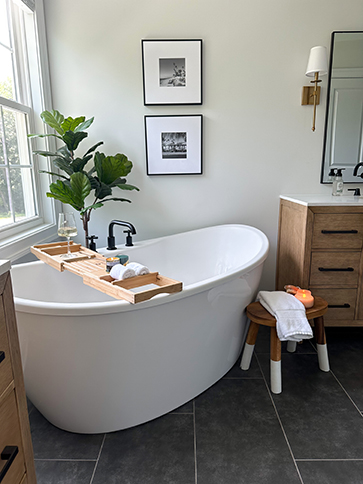 two framed photos  hanging over a bath tub