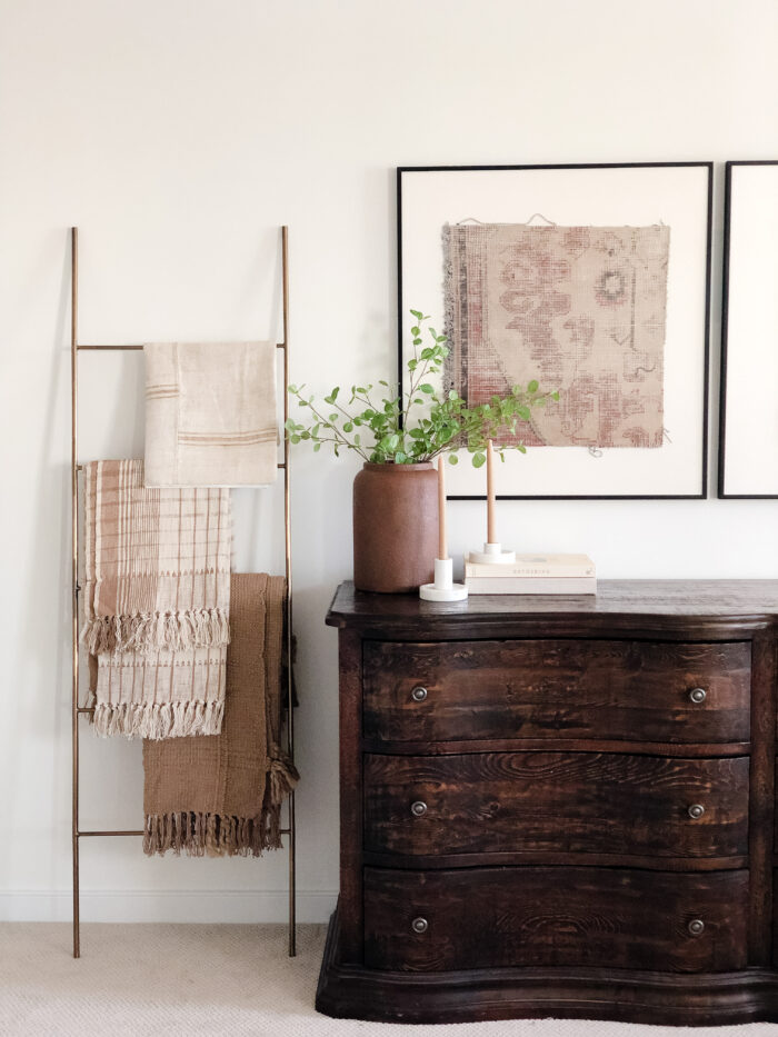 Hotel Room Decoration 101: A dresser with a plant and framed art 