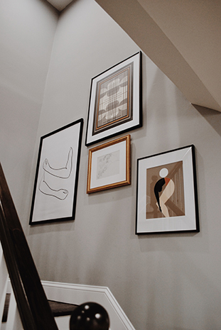 framed art hanging in a stairwell