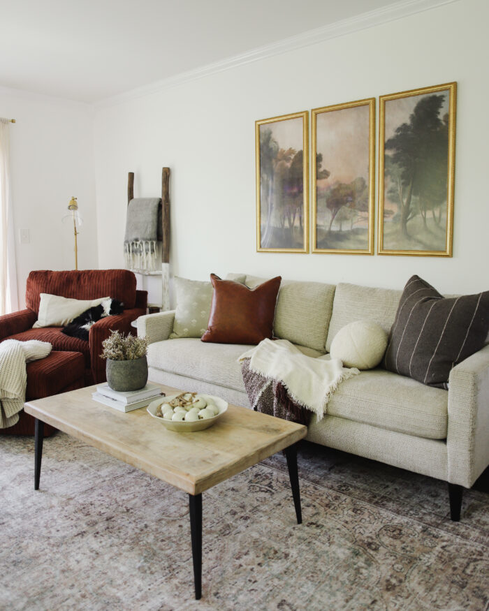 Gold frames above a couch in a living room