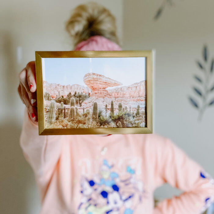 Creative inspiration: A woman holding a framed photo 