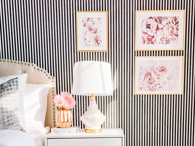 Stunning Accent Wall Ideas: A bold bedroom with framed floral prints. 
