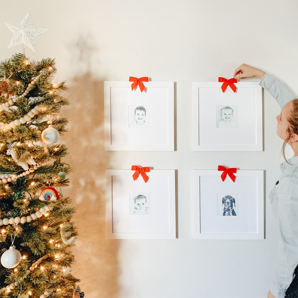 Custom Framing: 4 portraits hang beside a christmas tree