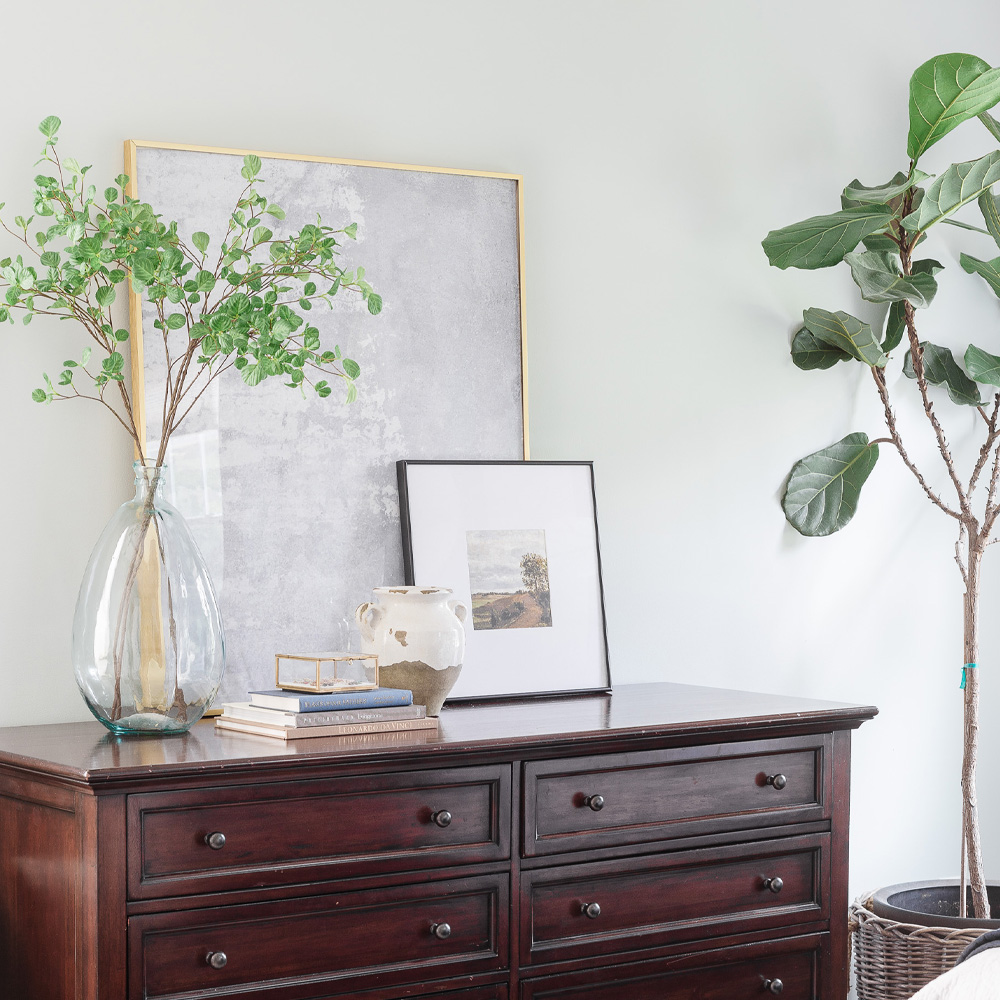 Eco-Friendly Decor Tips: Two Ashforld style frames on a bedroom dresser. 