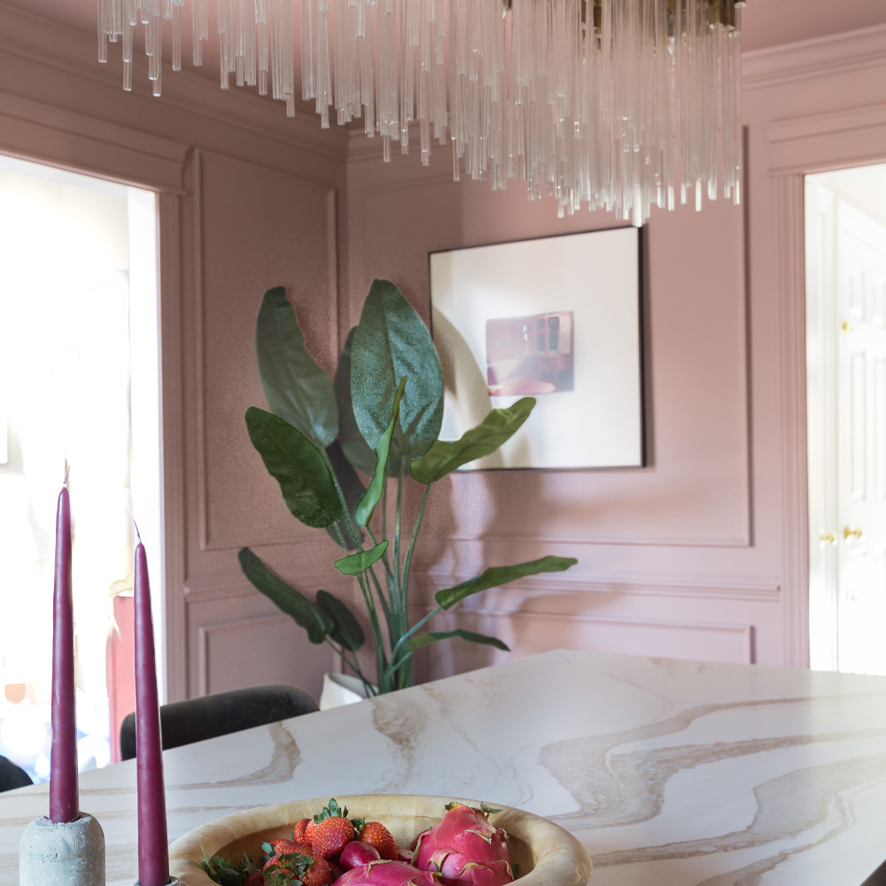 Eco-Friendly Decor Tips: A framed photo in a rose pink dining room. 