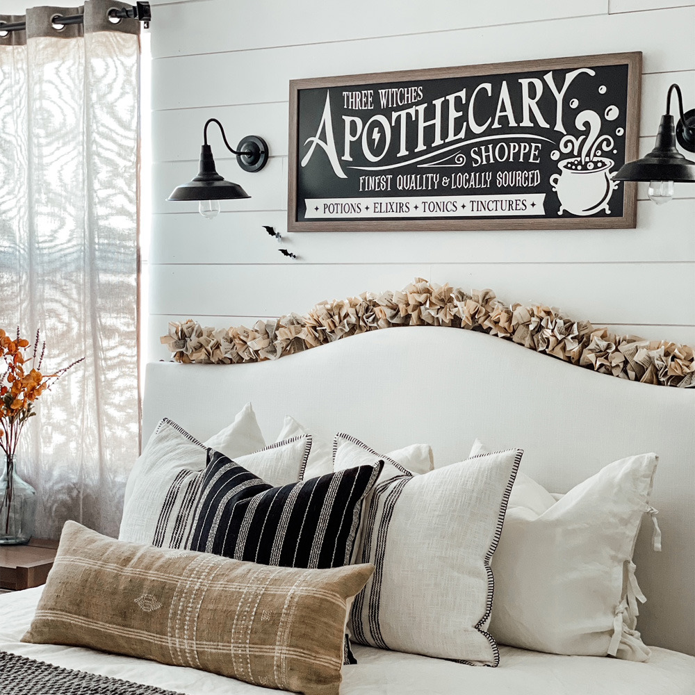 Custom Framing: A bedroom with large framed halloween style art. 