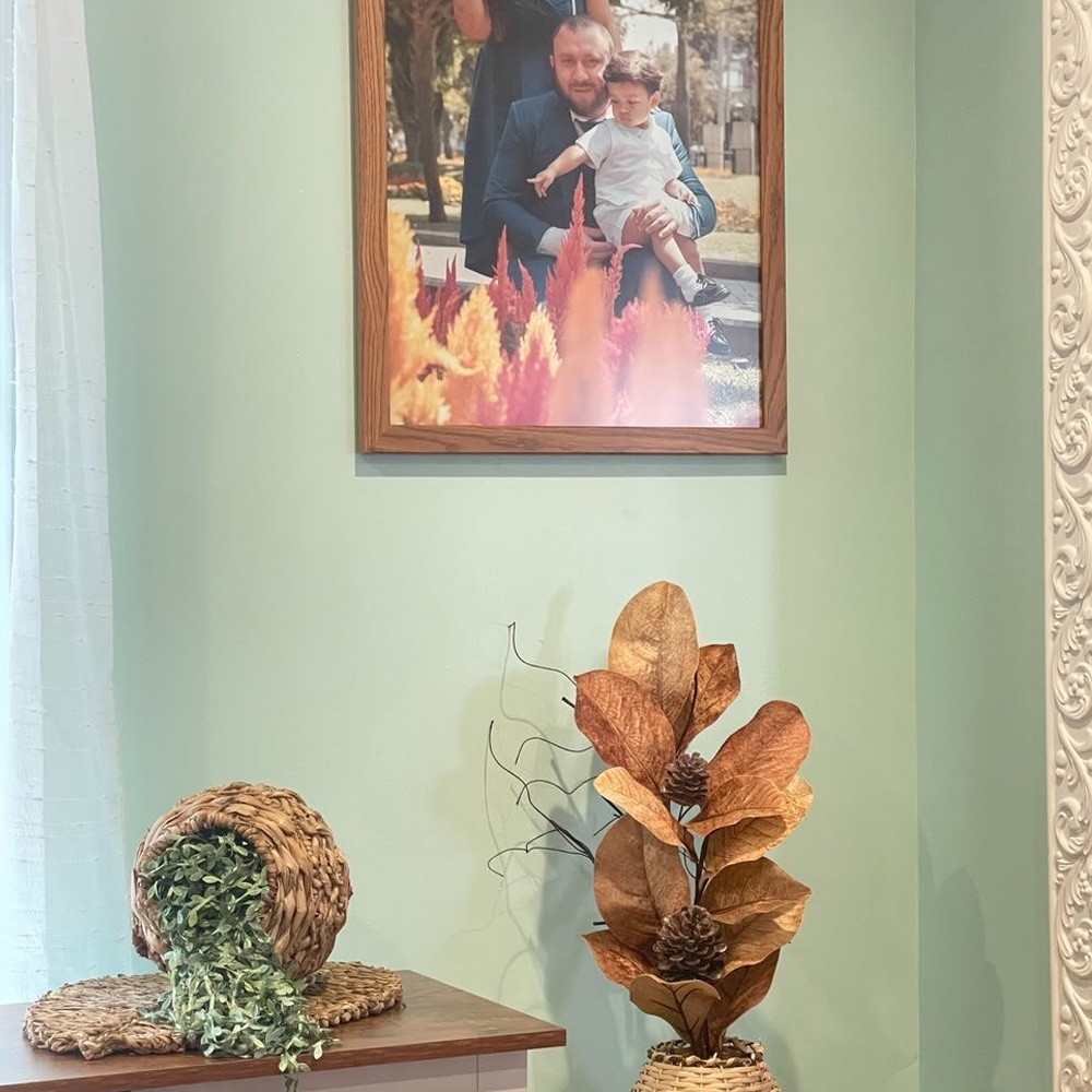 Family Picture Ideas: A family photo hung in a living room corner. 