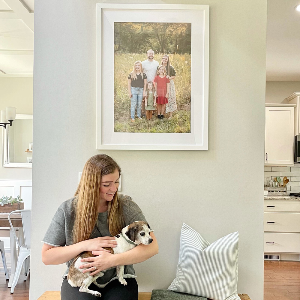 Family Picture Ideas: An outdoors family photo hung in a hallway.