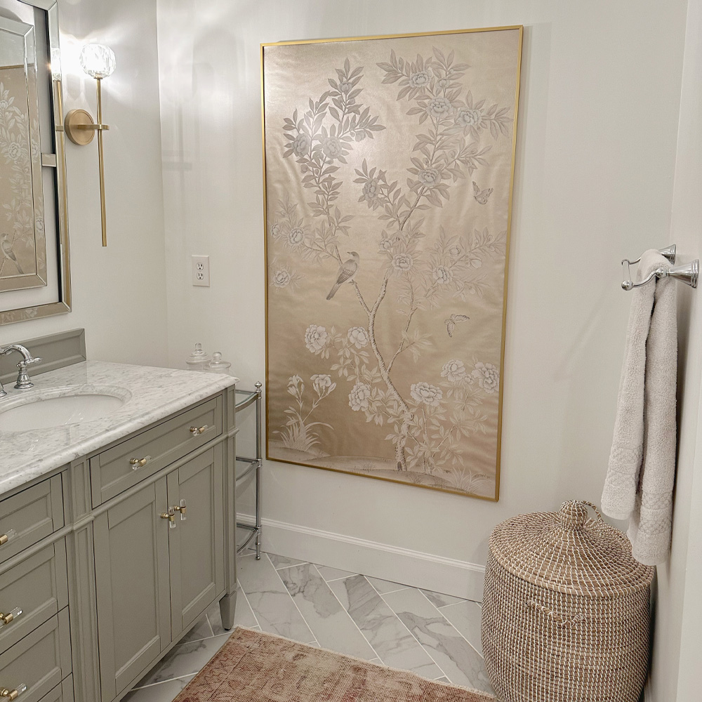 Bathroom Wall Decor Ideas: A Vintage style bathroom with a large decorative cloth is hung and framed by bath towels and wicker decor.