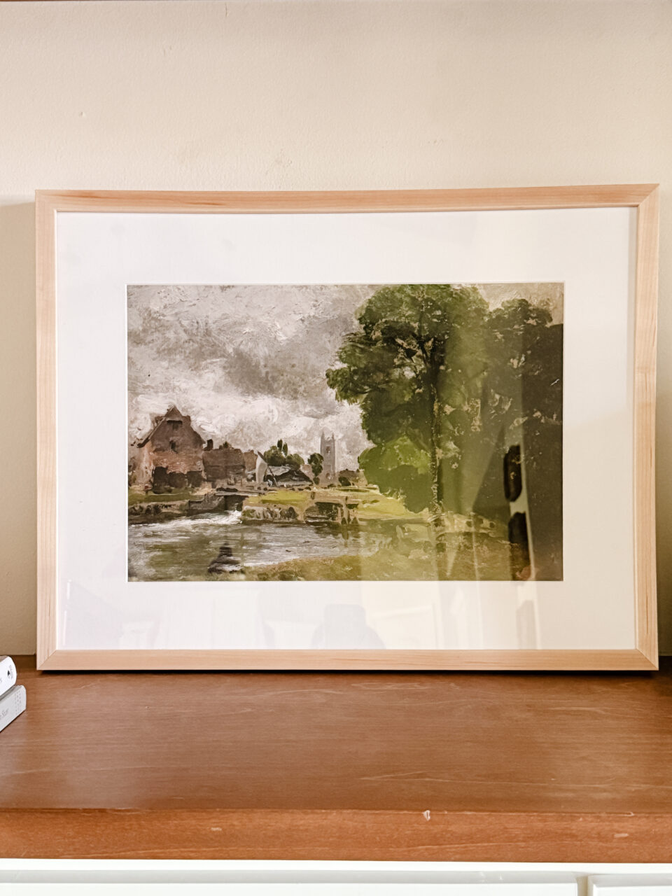 framed art on a shelf