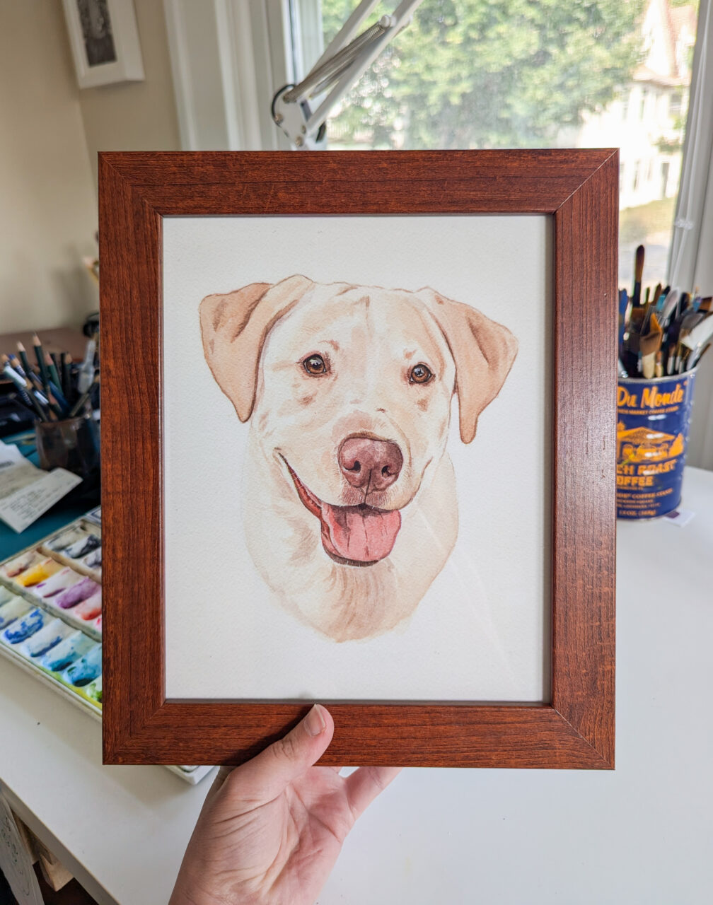 How to Price Art: A Simple Guide for Artists 13 person holding their framed pet art