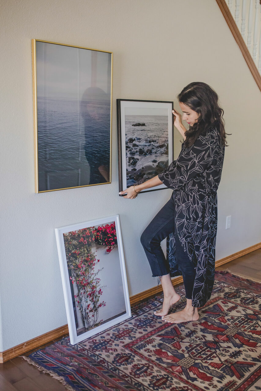 How to Price Art: A Simple Guide for Artists 6 artist hanging her artwork