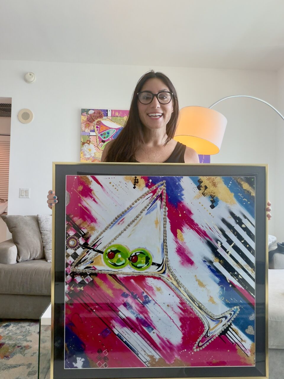 Local Framing vs Online Framing: What's the Real Difference? 2 artist holding her framed print